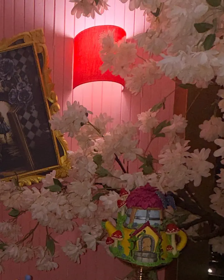 Cerezo en flor junto a una lámpara roja y una tetera decorativa